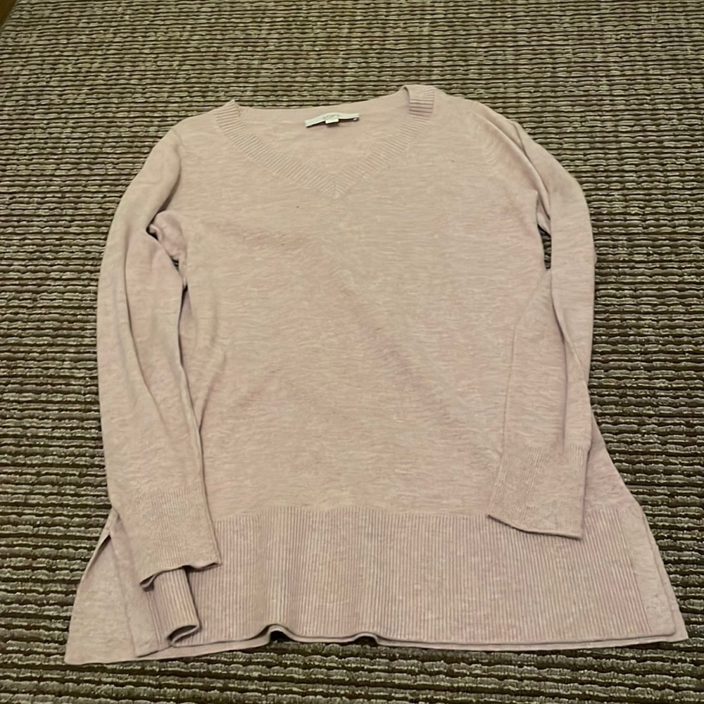 V Neck sweater with slits on the sides.